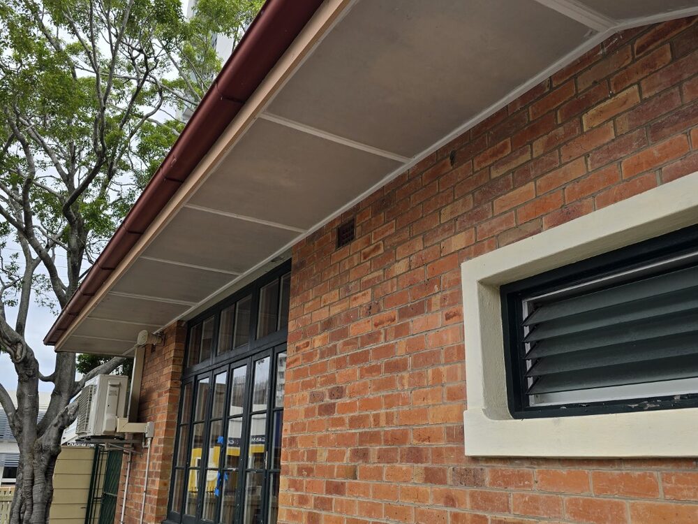 Eaves and wall sheeting on a brick building, reinstated after asbestos removal